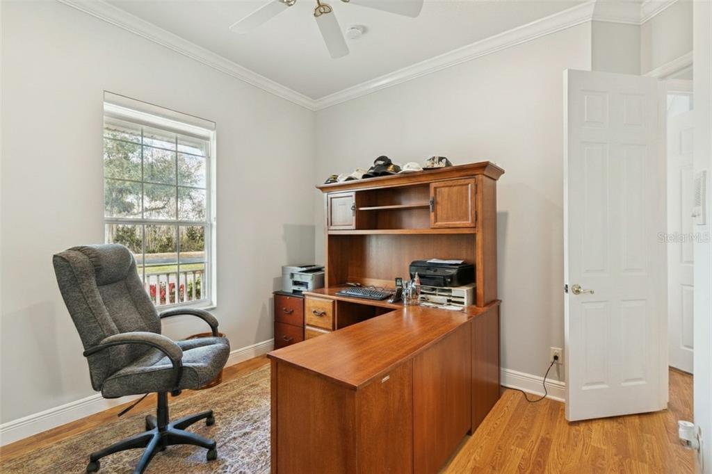 801 Glendora Road Kissimmee, FL 34759 - Photo 41 of 74 a room with a chair and wooden floor