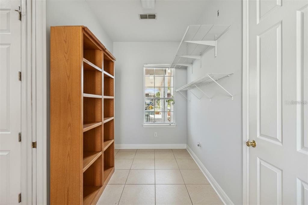 801 Glendora Road Kissimmee, FL 34759 - Photo 45 of 74 a view of empty room with windows and cabinet