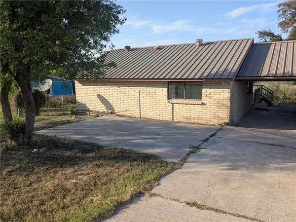 a view of a house with a yard and garage