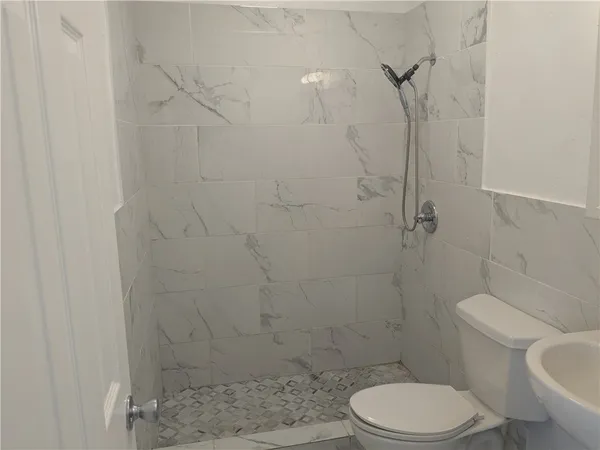 a white toilet and shower in a bathroom