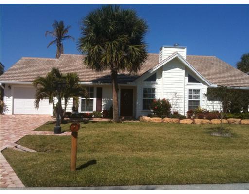 4331 Northeast Joes Point Road Jensen Beach, FL 34957 - Photo 1 of 8 a front view of a house with a garden and patio