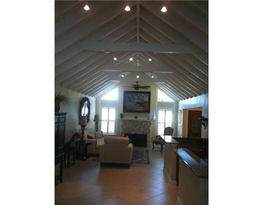 4331 Northeast Joes Point Road Jensen Beach, FL 34957 - Photo 2 of 8 a living room with furniture and a fireplace