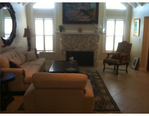 4331 Northeast Joes Point Road Jensen Beach, FL 34957 - Photo 4 of 8 a living room with furniture and a fireplace