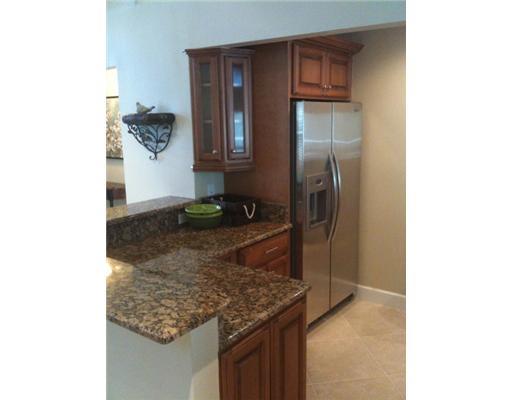 4331 Northeast Joes Point Road Jensen Beach, FL 34957 - Photo 5 of 8 a kitchen with a sink and refrigerator