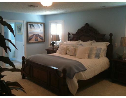 4331 Northeast Joes Point Road Jensen Beach, FL 34957 - Photo 7 of 8 a bedroom with a bed and painting on the wall