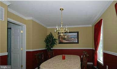205 Captain Brendt Drive Accokeek, MD 20607 - Photo 11 of 28 a dining room with furniture and chandelier