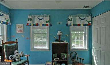 205 Captain Brendt Drive Accokeek, MD 20607 - Photo 16 of 28 a room that has a window and a chair in it