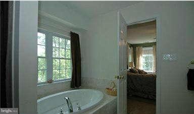 205 Captain Brendt Drive Accokeek, MD 20607 - Photo 19 of 28 a bathroom with a tub sink and mirror