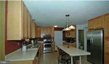 205 Captain Brendt Drive Accokeek, MD 20607 - Photo 9 of 28 a kitchen with stainless steel appliances granite countertop sink stove and refrigerator