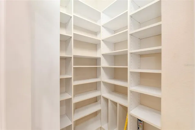 an empty room with a ceiling fan and a window