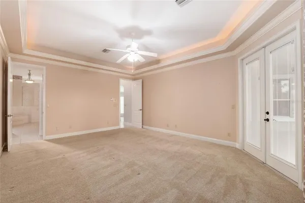 a spacious bathroom with a sink a toilet a mirror and bathtub