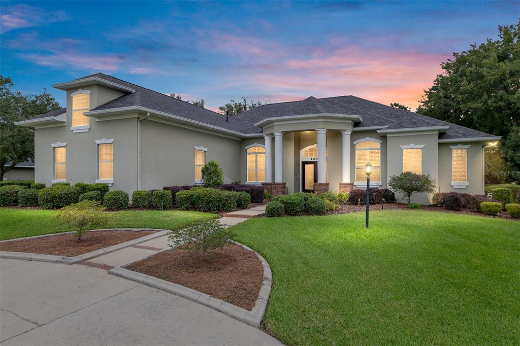4815 Southeast 12th Place Ocala, FL 34471 - Photo 2 of 59 a front view of a house with a garden