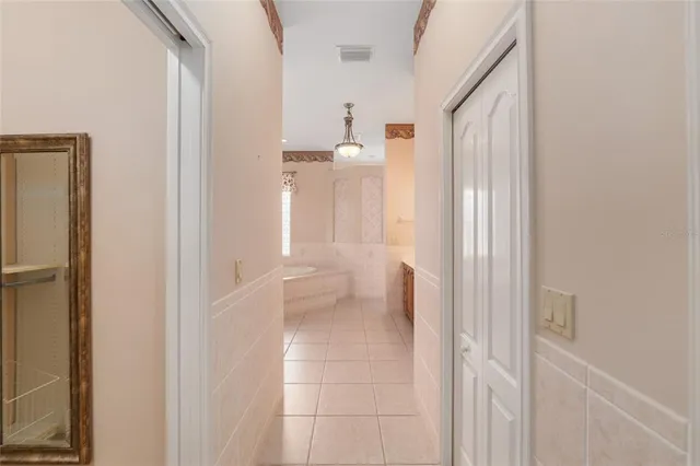 a bathroom with a granite countertop toilet sink and mirror