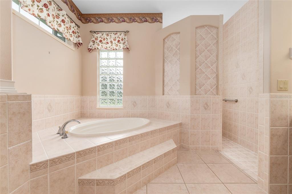 4815 Southeast 12th Place Ocala, FL 34471 - Photo 23 of 59 a bathroom with a granite countertop sink a toilet and shower