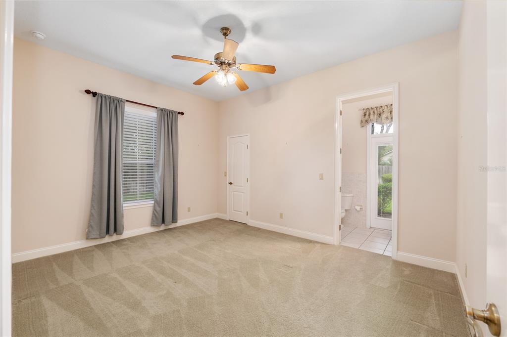 4815 Southeast 12th Place Ocala, FL 34471 - Photo 27 of 59 an empty room with windows and fan