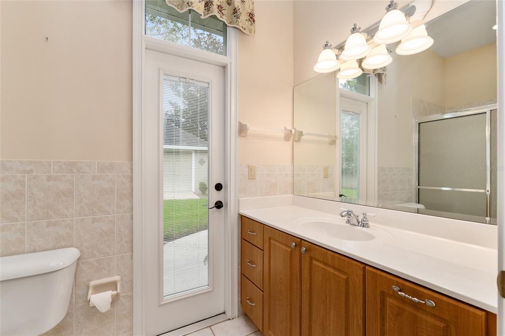 4815 Southeast 12th Place Ocala, FL 34471 - Photo 29 of 59 a bathroom with a sink a toilet and a large mirror
