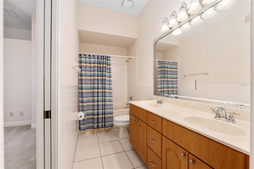 4815 Southeast 12th Place Ocala, FL 34471 - Photo 32 of 59 a spacious bathroom with a sink double vanity and a shower