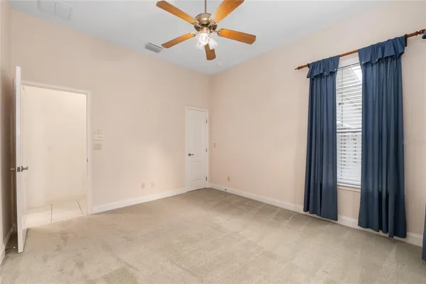 a view of a livingroom with a ceiling fan and window