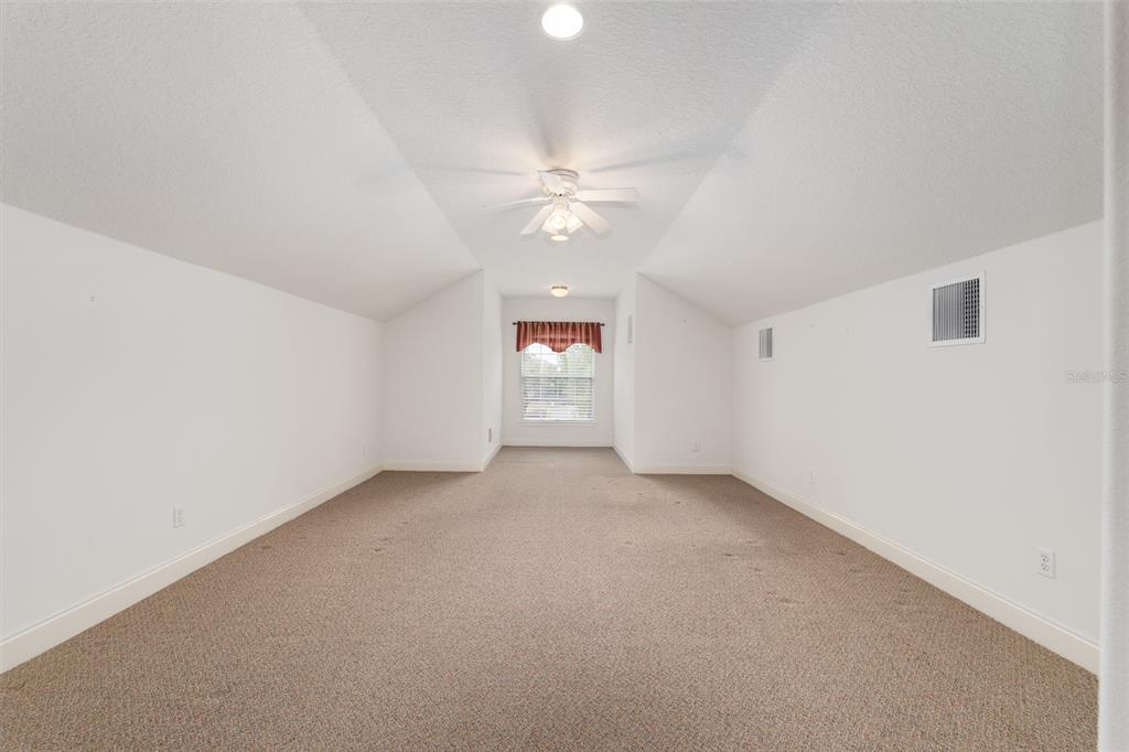 4815 Southeast 12th Place Ocala, FL 34471 - Photo 37 of 59 an empty room with a window and a ceiling fan