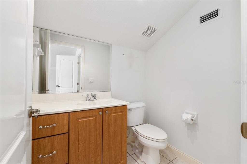 4815 Southeast 12th Place Ocala, FL 34471 - Photo 40 of 59 a bathroom with a granite countertop toilet sink and mirror