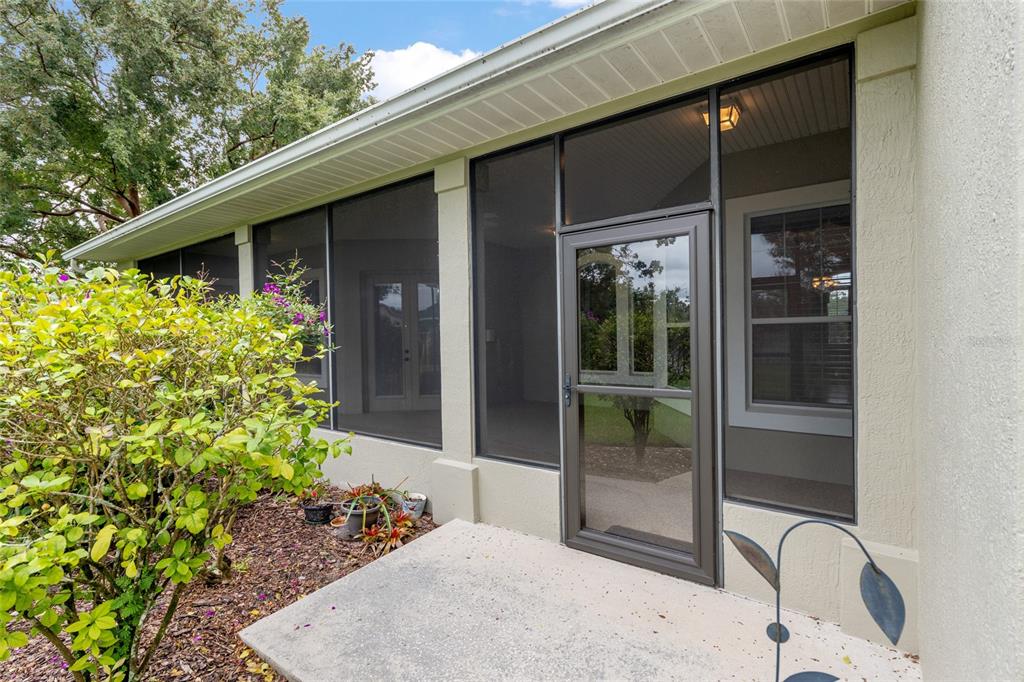 4815 Southeast 12th Place Ocala, FL 34471 - Photo 51 of 59 a backyard of a house with large window and potted plants
