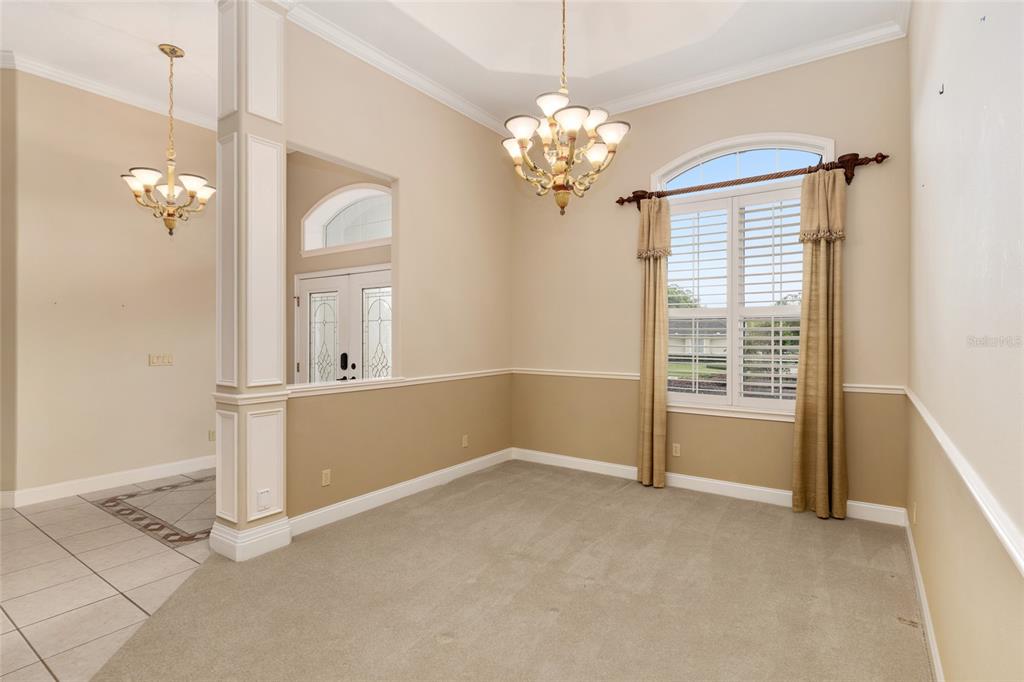 4815 Southeast 12th Place Ocala, FL 34471 - Photo 9 of 59 a view of a livingroom with a chandelier fan and windows