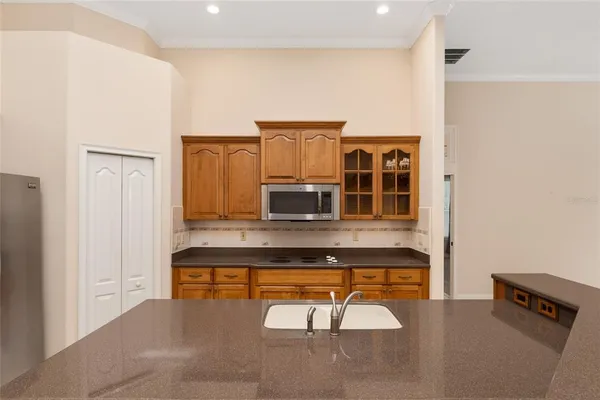 a kitchen with stainless steel appliances granite countertop a sink refrigerator stove and microwave