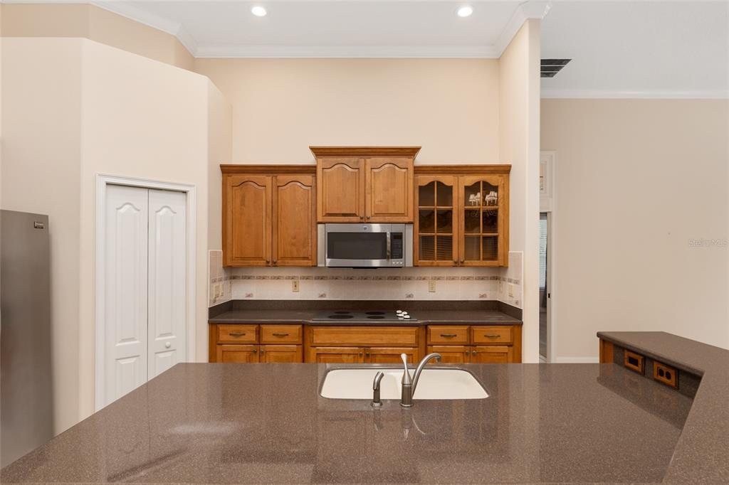 4815 Southeast 12th Place Ocala, FL 34471 - Photo 10 of 59 a living room with stainless steel appliances kitchen island granite countertop furniture and a fireplace