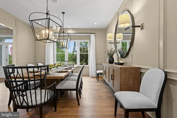 a view of a dining room with furniture a chandelier and wooden floor