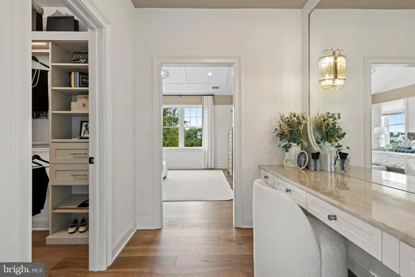 a hallway with cabinets and wooden floor