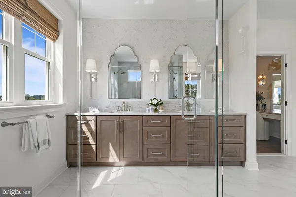 a bathroom with a sink a vanity and a large mirror