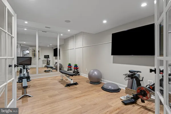 a room with gym equipment and a flat screen tv