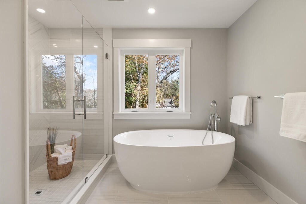 445 Lowell Street Lexington, MA 02420 - Photo 21 of 41 a white bath tub sitting in a bathroom next to a window