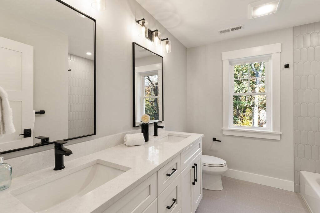 445 Lowell Street Lexington, MA 02420 - Photo 23 of 41 a bathroom with a granite countertop sink mirror and a toilet