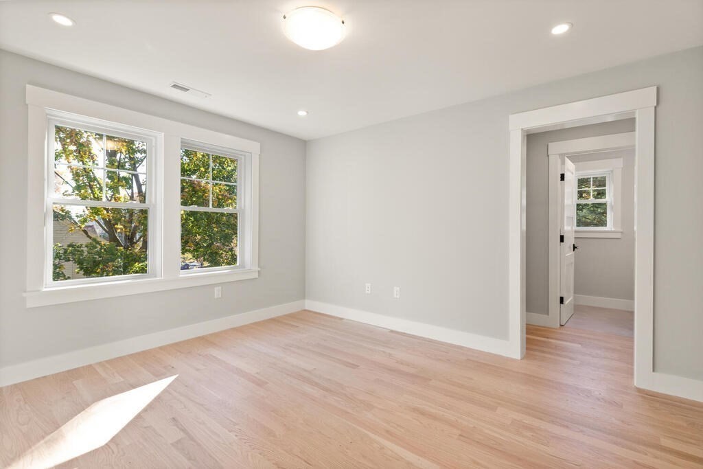 445 Lowell Street Lexington, MA 02420 - Photo 24 of 41 an empty room with wooden floor and a window
