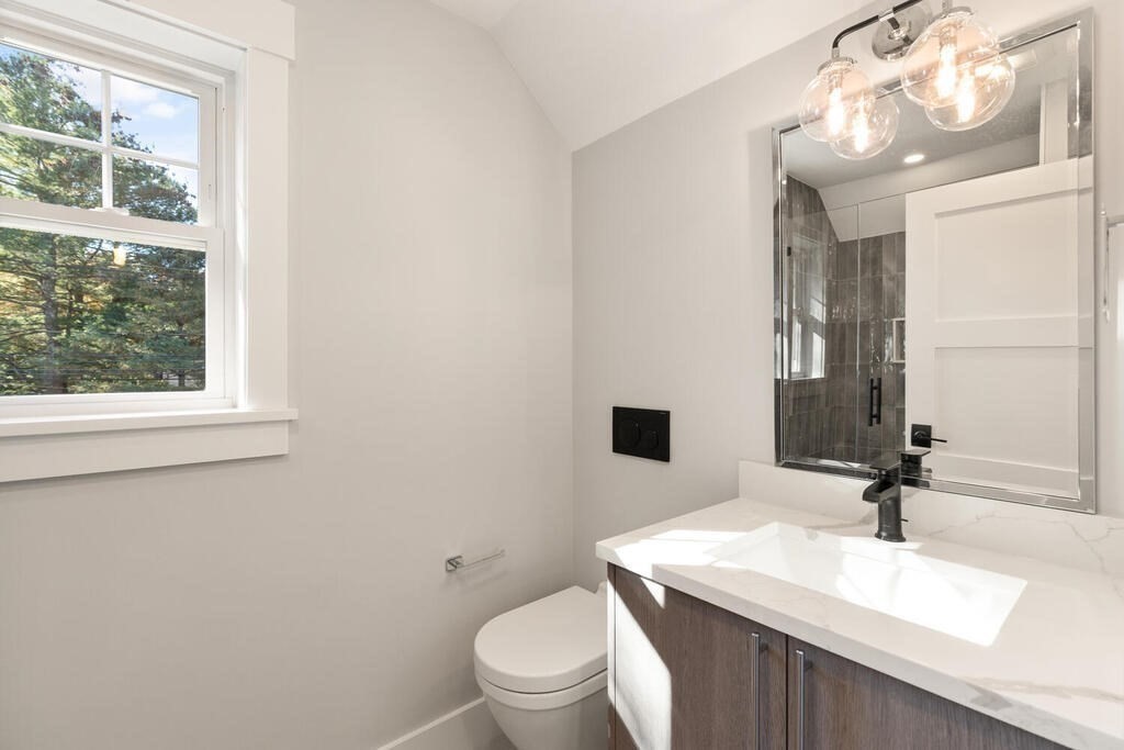 445 Lowell Street Lexington, MA 02420 - Photo 25 of 41 a bathroom with a sink a toilet and a mirror