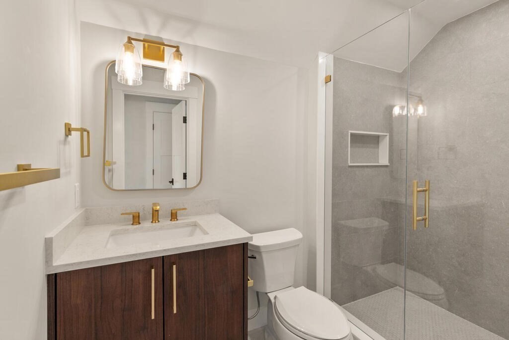 445 Lowell Street Lexington, MA 02420 - Photo 26 of 41 a bathroom with a sink vanity mirror and toilet