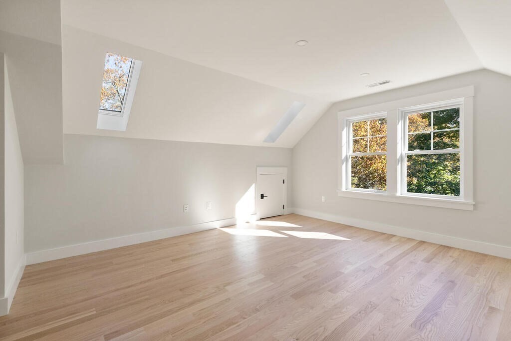 445 Lowell Street Lexington, MA 02420 - Photo 28 of 41 an empty room with wooden floor and windows