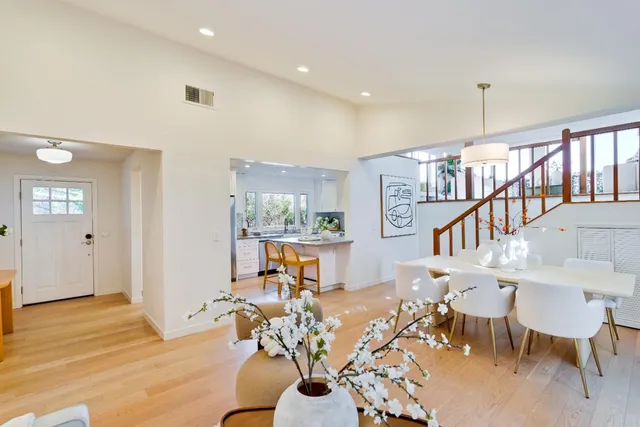 a living room with furniture a dining table and a rug