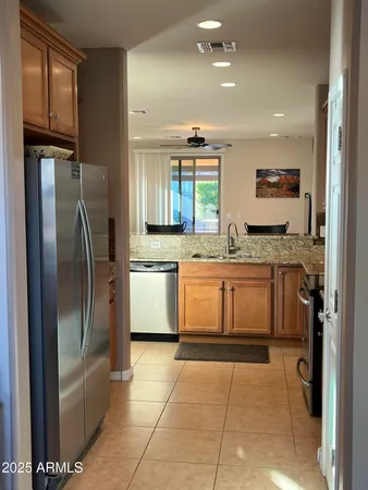 a large kitchen with a stove a sink dishwasher a refrigerator and a microwave oven