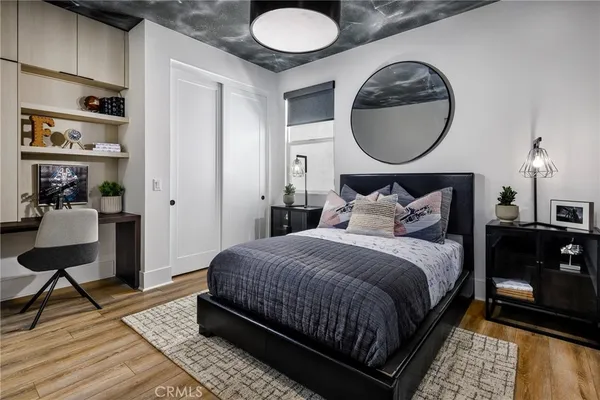 a bedroom with bed and a mirror