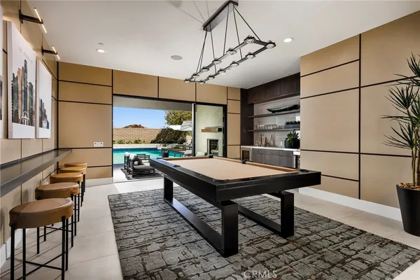 a room with furniture pool table and flat screen tv