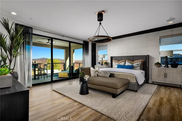 a spacious bedroom with a bed couch and a large window