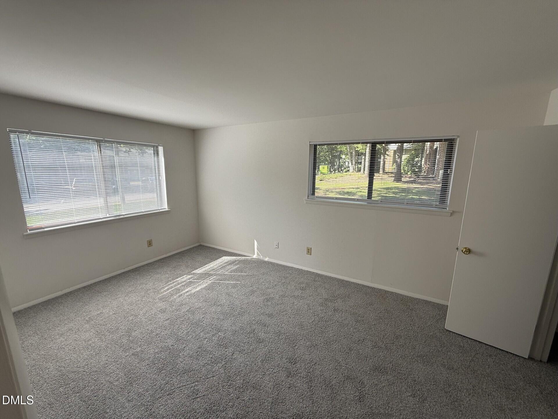 1299 Schaub Drive, Unit D Raleigh, NC 27606 - Photo 11 of 16 an empty room with windows