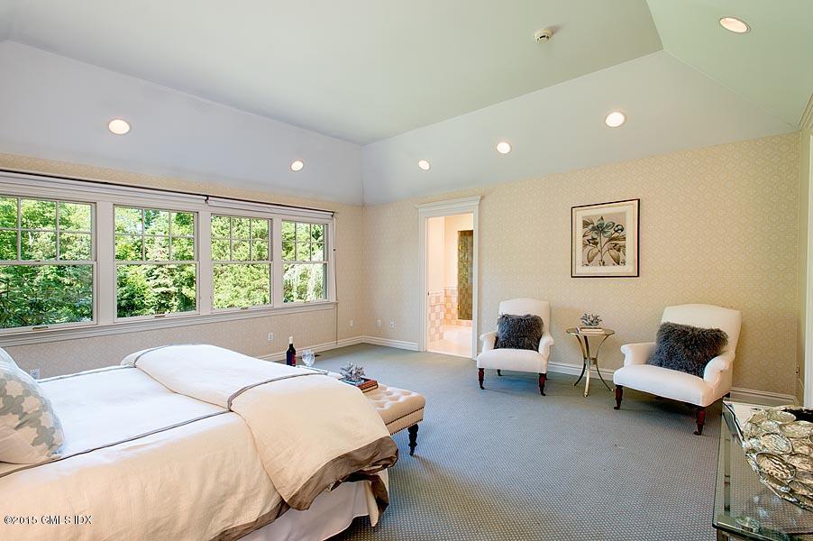 122 Clapboard Ridge Road Greenwich, CT 06830 - Photo 20 of 39 a bed room with a bed and a couch