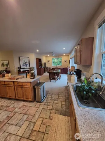 a living room with furniture a large window and gym equipment