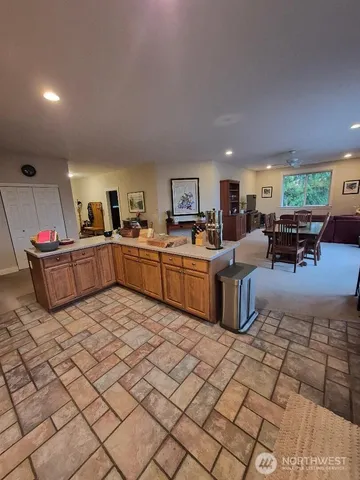 a kitchen with stainless steel appliances a stove a sink a microwave a refrigerator and cabinets