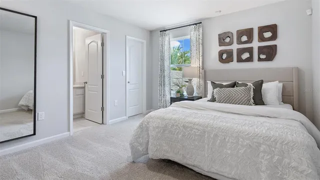 a bedroom with a bed and painting on the wall