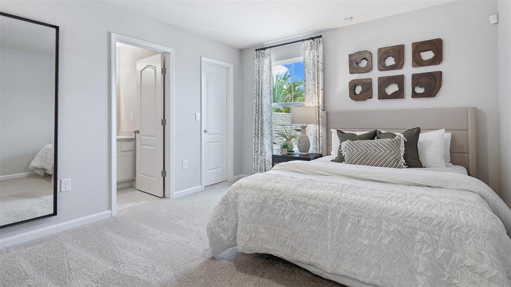 99 Blue Hvn Road St. Augustine, FL 32095 - Photo 12 of 45 a bedroom with a bed and painting on the wall