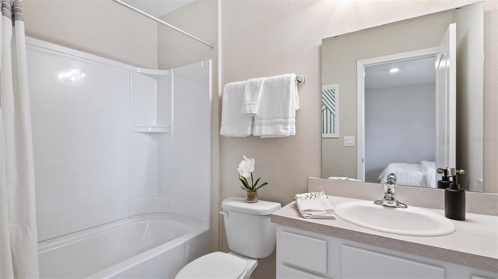 99 Blue Hvn Road St. Augustine, FL 32095 - Photo 13 of 45 a bathroom with a granite countertop sink a toilet and shower